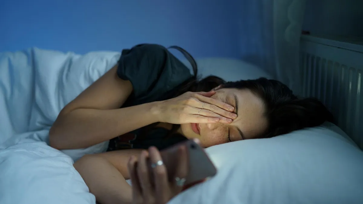 In bed on phone tired