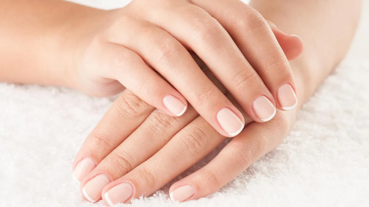 Female Hands Close up crossed on white towel