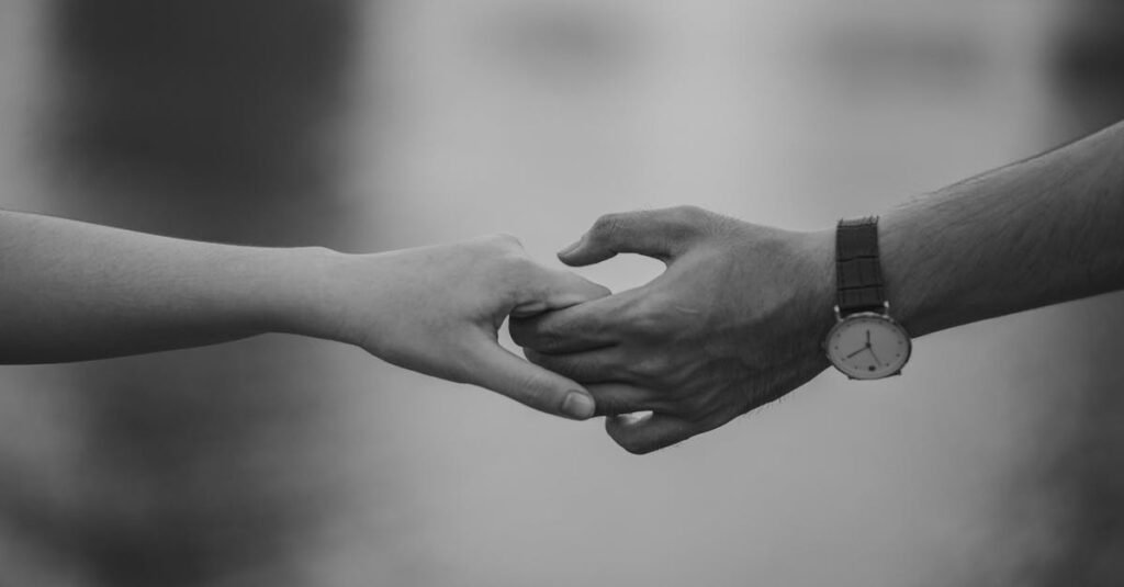 Monochrome image of two hands holding, symbolizing love and connection. Alcohol Use Disorder